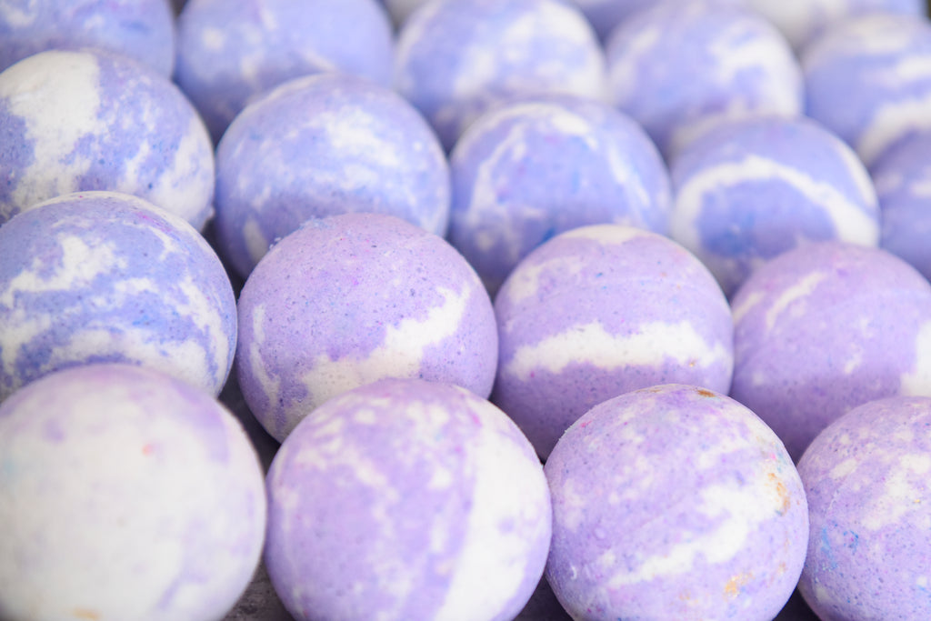 Purple and white handmade bath bombs. Made with shea butter and other skin loving oils in Knoxville, TN
